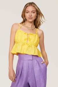 Style this tie-front peplum top by ASHLEY PARK x RTR with high-waisted jeans for a bohemian inspired summer look.