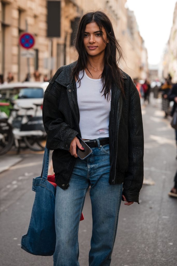 Fashion blogger wearing an affordable tank top paired with an oversized jacket for a trendy summer look