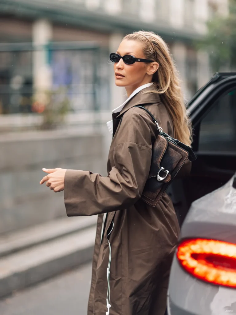 Bella Hadid in a chic brown-toned coat and trousers during Paris street style moment